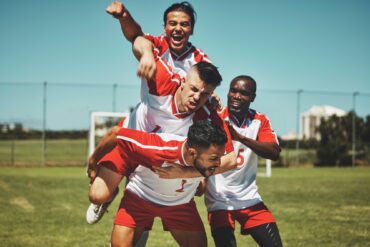 Soccer player, soccer and soccer field, winner and team, diversity and celebrate goal, athlete happ